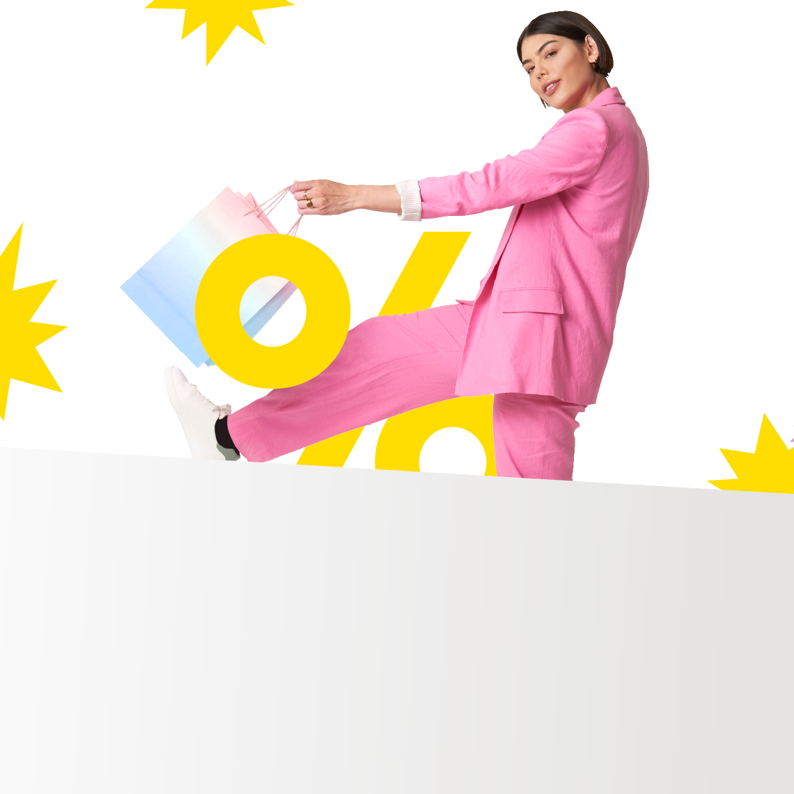woman dressed in pink with a shopping bag